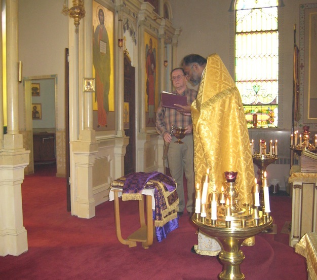 Father John blesses the new icon table cloths