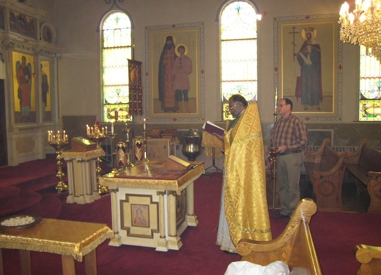 Father John blesses the table icons