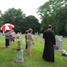 Photo of Fr. Edward blessing and parishoners at St. Michael's Cemetery