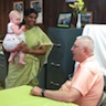 Photo of Matushka Suja and baby visiting with another parishoner