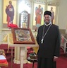 Photo of Father John with the icon of St. Anna