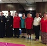 Group photo of Archbishop Mark, Father John, and representatives from local charities