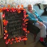 Photo of resident near lunch sign at Serenity Gardens