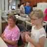 Photo of Stasi serving iced teas during lunch at Serenity Gardens