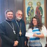Photo of Alli Rake, Executive Director of the Lower Anthracite United Way, accepting a check from Fr. Ignatius and Archbishop Mark at the annual_picnic