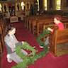 Photo of parishioners decorating inside the church for Christmas.