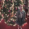 Photo of a young parish girl in front of the Christmas tree