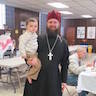 Photo of Fr. Ignatius being awarded the Diocesan Purple Skufia for his service