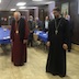 Photo of Father Vjekoslav and Bishop Mark leading the prayer at the St Michael's Day luncheon. Six guests are also shown.