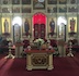 Landscape mode photo of the altar, with poinsettias spaced across the front of the altar and on the three steps