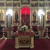 Portrait mode photo of the altar, with poinsettias spaced across the front of the altar and on the three steps