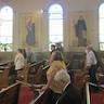 Photo parishoners standing and listening to Fr. Vjekoslav during the Pascha service