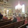 Photo parishoners standing and listening to Fr. Vjekoslav during the Pascha service