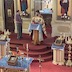 Photo of Fr. Vjekoslav standing at a lecturn, reading the bible, with his back facing the alter. A man holding a candle in a tall candle holder stands at his right.