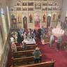 Photo taken from the choir loft and showing the congregation venerating the cross following liturgy.