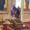 Photo of His Eminence, Archbishop Mark giving communion to Father Vjekoslav