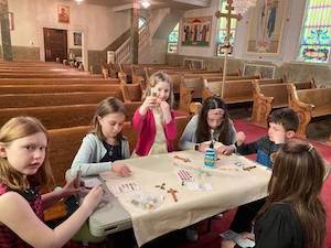 Photos of students decorating crosses during Sunday school.