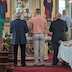 Five men stand facing the altar as Fr. Barnabas emerges, presenting the Holy Gifts during the Pascha service.