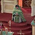 Wearing green vestments, Father Barnabas Fravel kneels in front of the Royal Doors, facing the congregation.