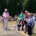 A group of parishioners standing outside at St. Michael's cemetery, reading from prayer books.