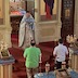 Father Barnabas stands in front of the Royal Doors and is holding the Royal Gifts. Two alter servers are standing in front of him.