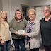 Sandy Tosca is standing and posing with three other women while presenting a check from the church to Central Susquehanna Opportunities. Sandy is third from the left and is handing the check to the woman who is second from the left. All of them are smiling, and unfortunately, I do not know any of their names. Sorry!